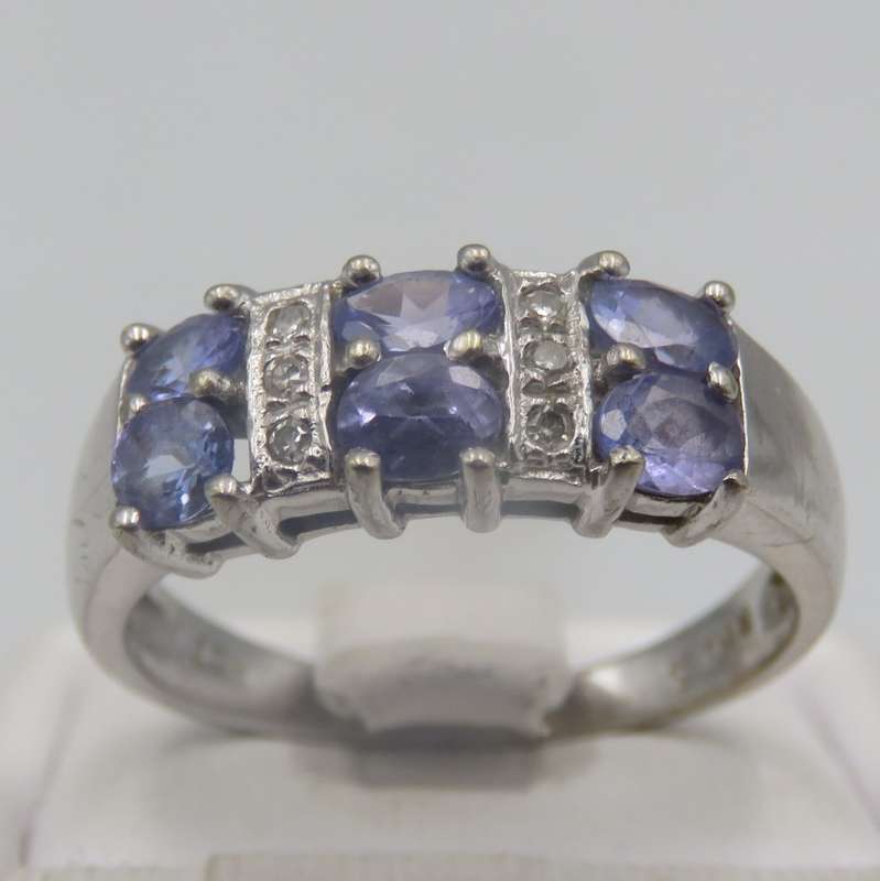 9kt white gold ring with 6 small diamonds and 6, iolites. Weight 3.5g , Size O