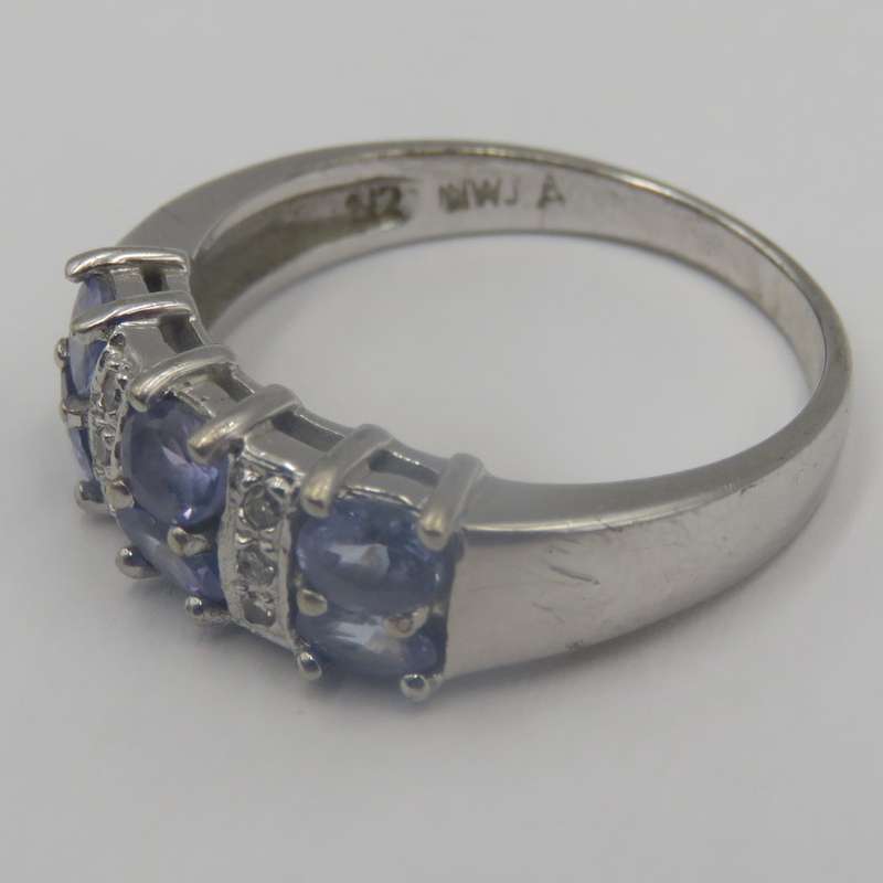 9kt white gold ring with 6 small diamonds and 6, iolites. Weight 3.5g , Size O