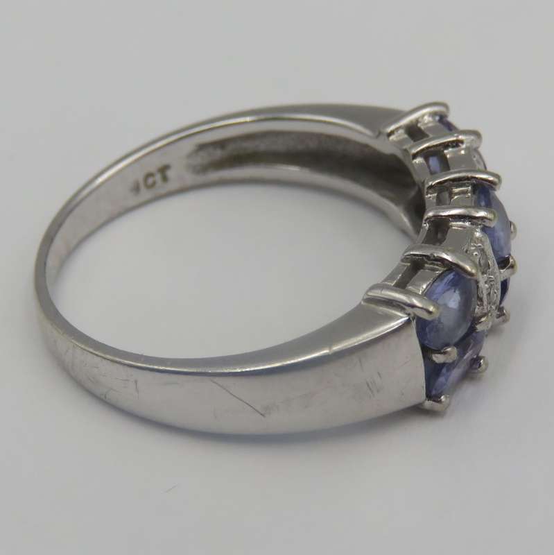 9kt white gold ring with 6 small diamonds and 6, iolites. Weight 3.5g , Size O
