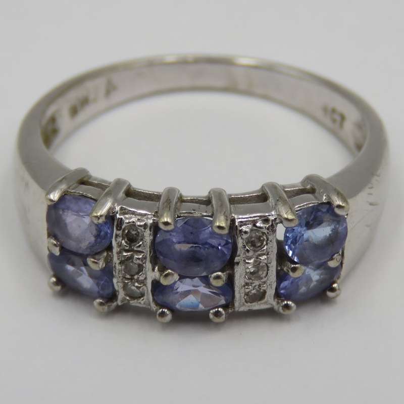 9kt white gold ring with 6 small diamonds and 6, iolites. Weight 3.5g , Size O