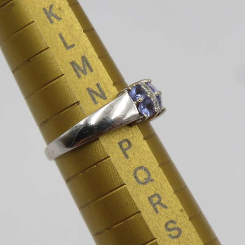 9kt white gold ring with 6 small diamonds and 6, iolites. Weight 3.5g , Size O