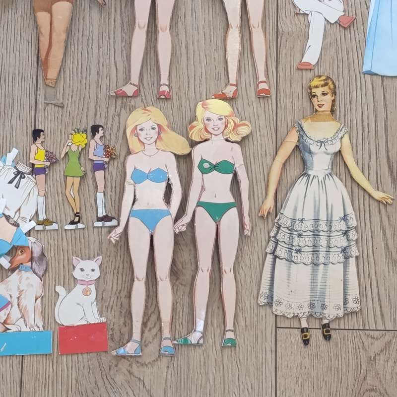 Large lot of vintage paper dolls with various dresses