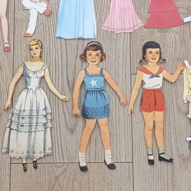 Large lot of vintage paper dolls with various dresses