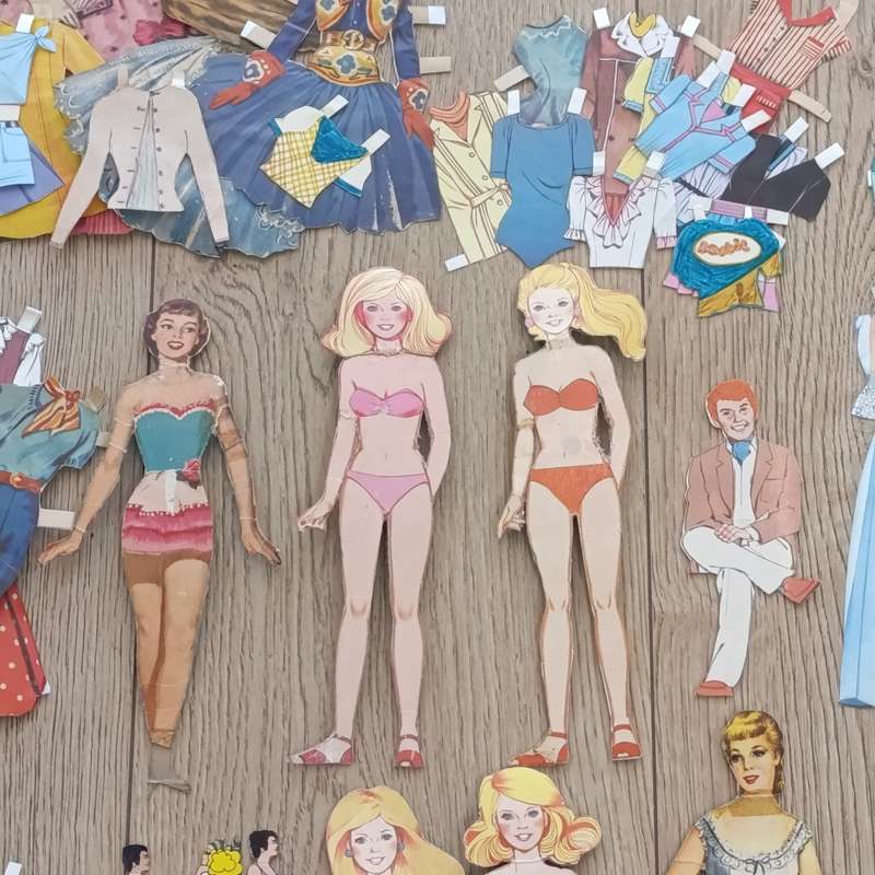 Large lot of vintage paper dolls with various dresses