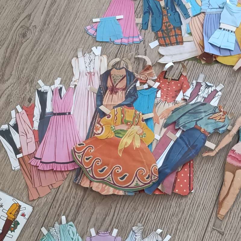 Large lot of vintage paper dolls with various dresses