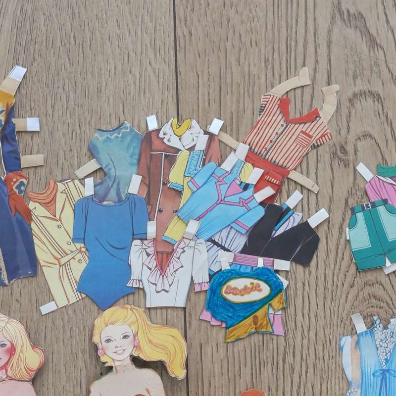 Large lot of vintage paper dolls with various dresses