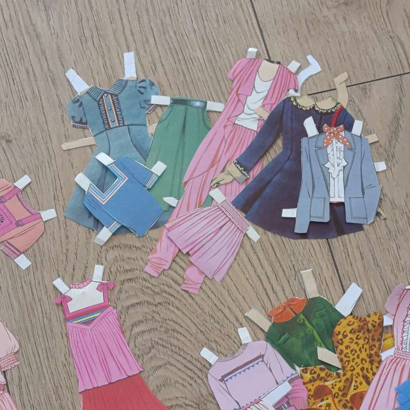 Large lot of vintage paper dolls with various dresses
