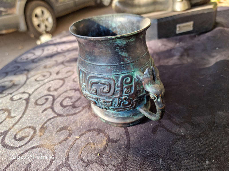 An archaic style bronze vassel decorated with taotie masks China, 20th century
