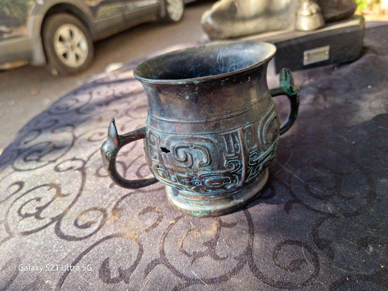 An archaic style bronze vassel decorated with taotie masks China, 20th century