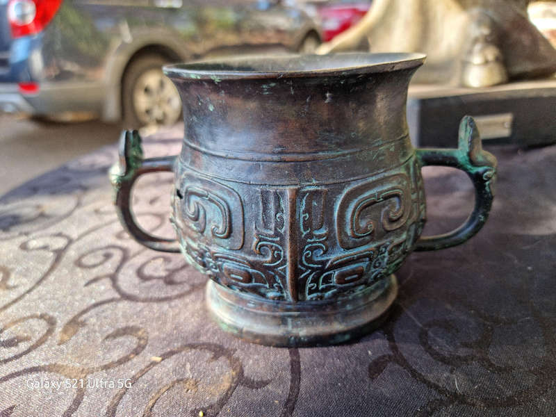 An archaic style bronze vassel decorated with taotie masks China, 20th century
