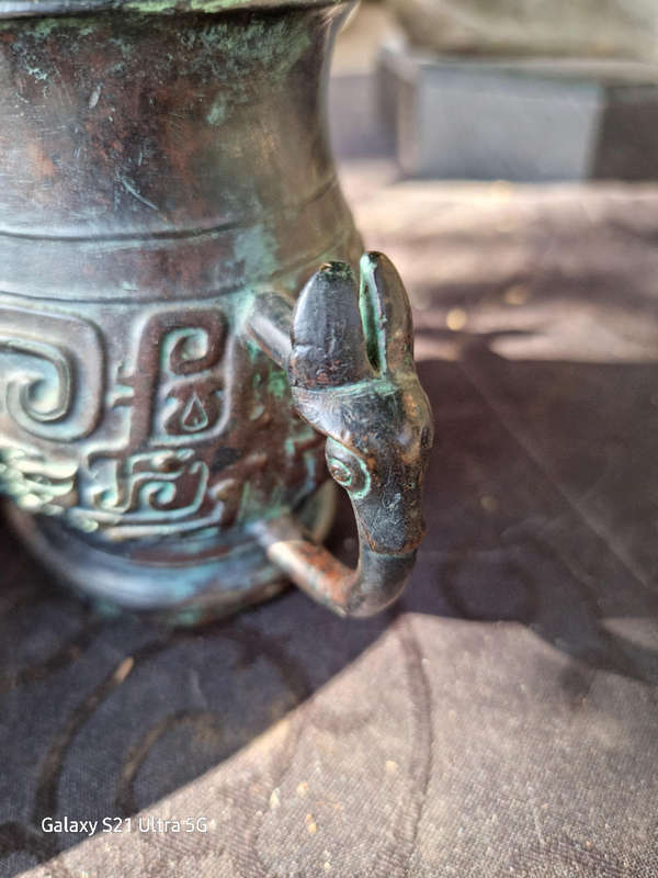 An archaic style bronze vassel decorated with taotie masks China, 20th century