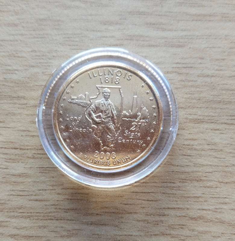 America Gold coloured Obama certified quarter dollar.