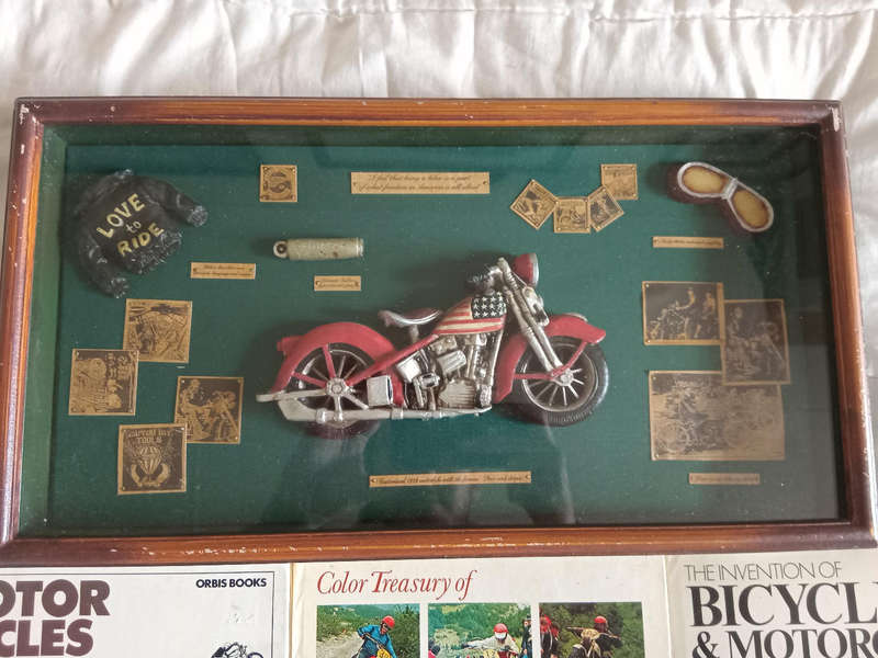 Motorbike souvenir display with 3 books