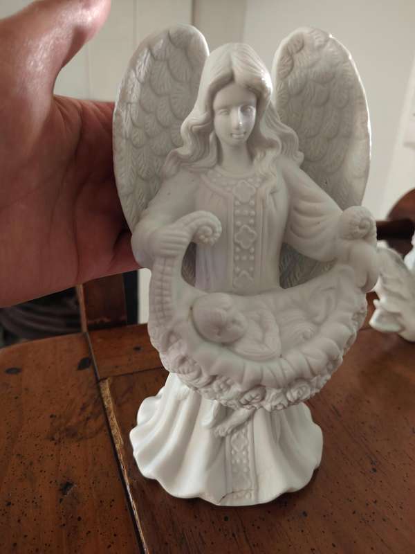 Beautiful ceramic angel holding cradle