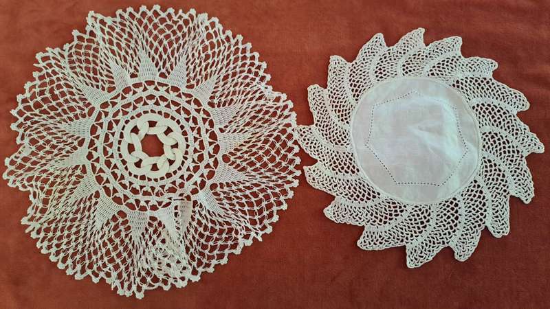 Two unusual, white, crochet doilies 20cm and 25cm
