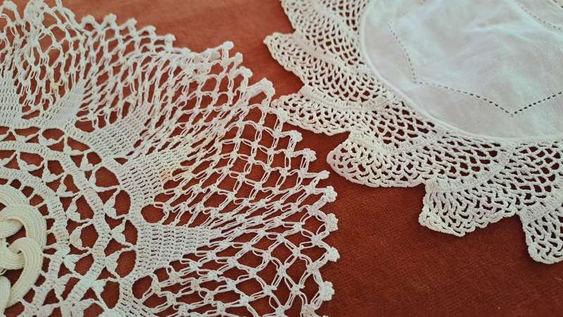 Two unusual, white, crochet doilies 20cm and 25cm
