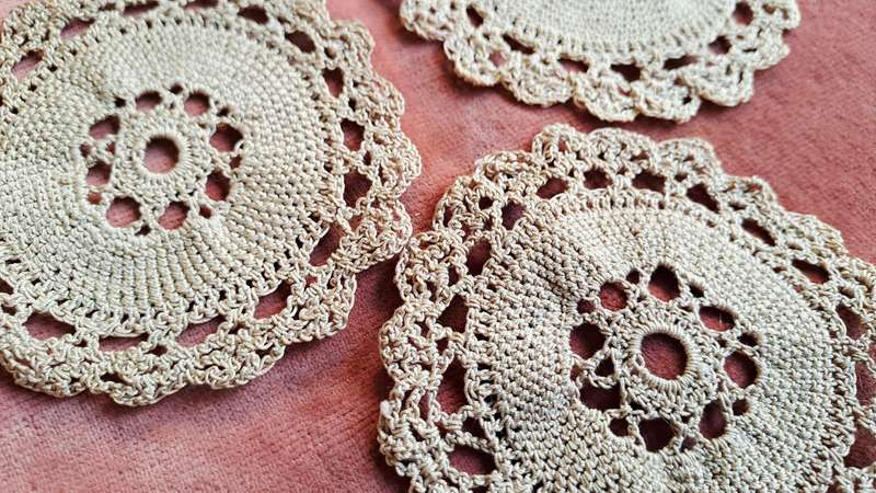 Three small ecru doilies 9 cm