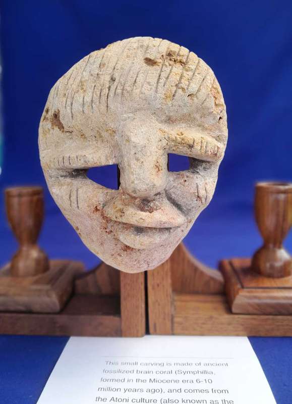 Fossilized  Carved Coral  Animist Mask on assembled Wooden Stand