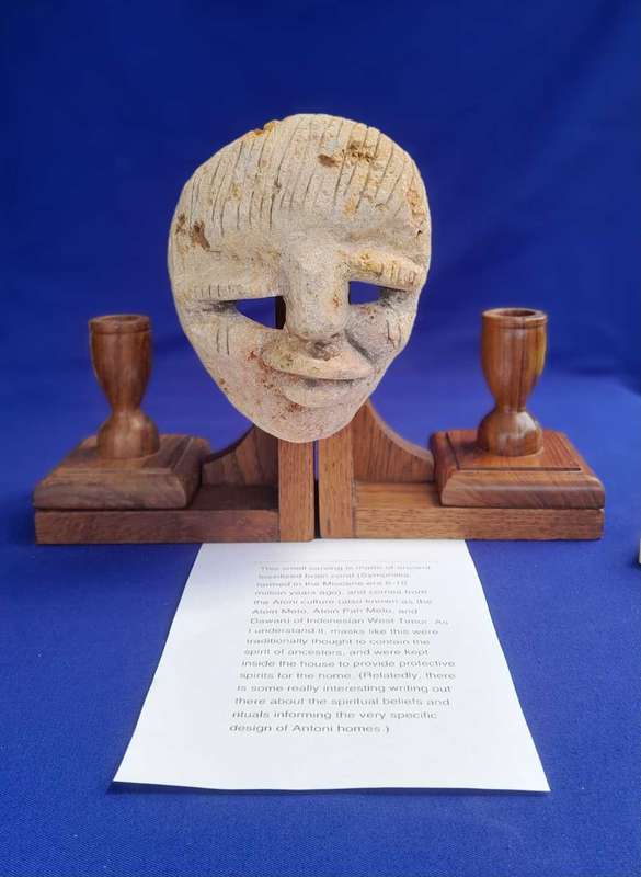 Fossilized  Carved Coral  Animist Mask on assembled Wooden Stand