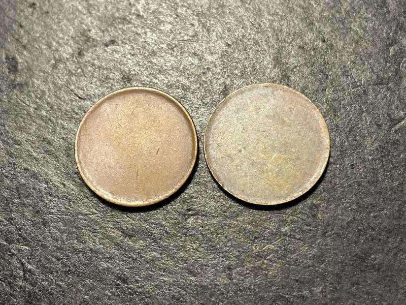 Two unidentified blank coin planchets - roughly the size of a 1 cent