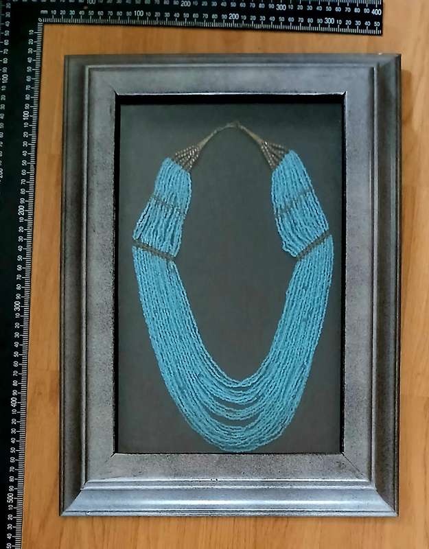 Beaded necklace (?) in frame