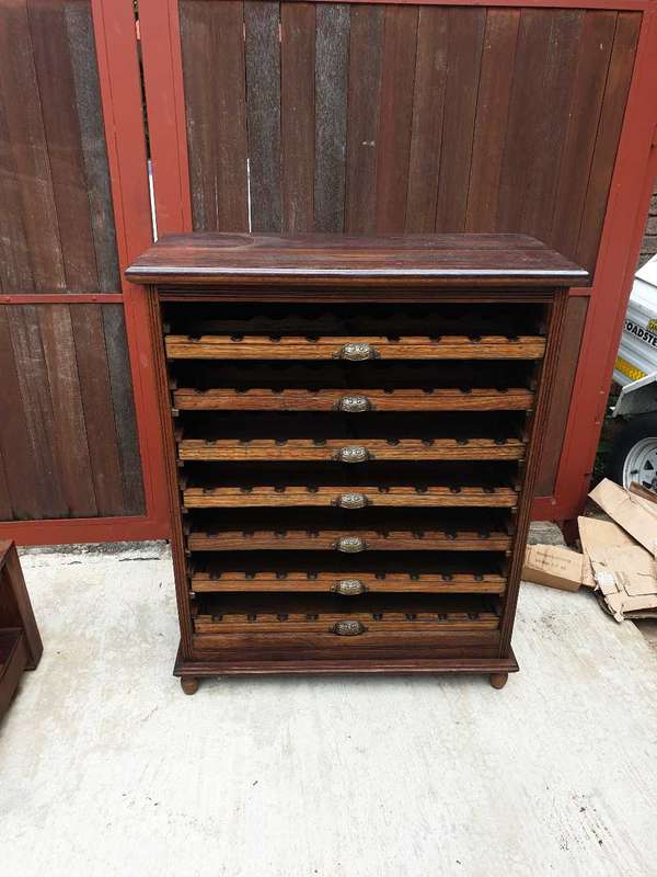 56 bottle antique mahogany wood wine rack with brass handles.