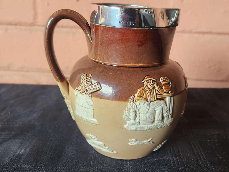 LATE VICTORIAN DOULTON LAMBETH JUG WITH A HALLMARKED SILVER RIM