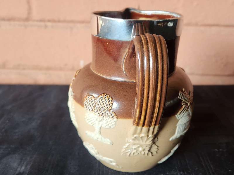 LATE VICTORIAN DOULTON LAMBETH JUG WITH A HALLMARKED SILVER RIM