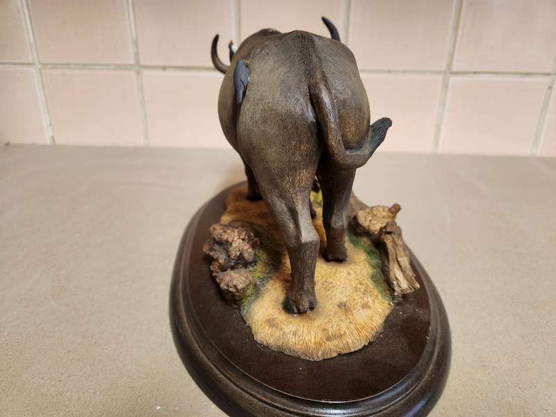 THE SILKWOODS OF KNYSNA MILLENIUM BUFFALO SCULPTURE ON A WOODEN BASE