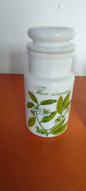 A Collection Of Milk Glass Containers With Lids