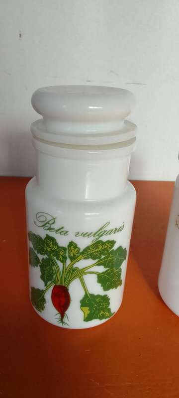 A Collection Of Milk Glass Containers With Lids