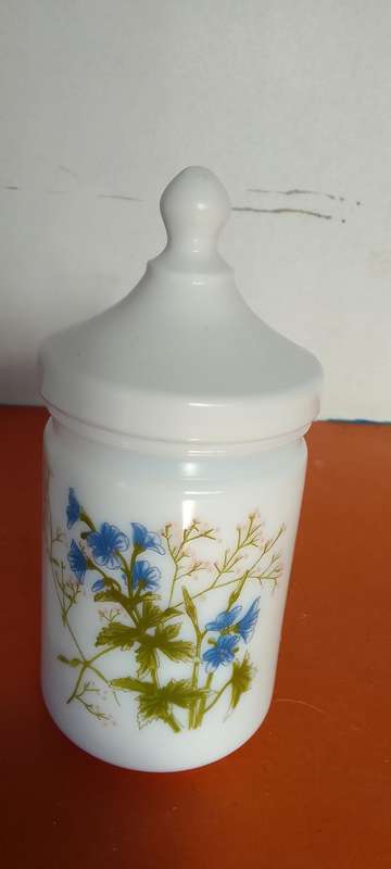 A Collection Of Milk Glass Containers With Lids