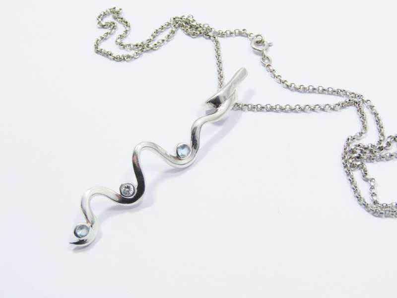 A Beautiful Swirl Design Zirconia Pendant on Chain in Sterling Silver.