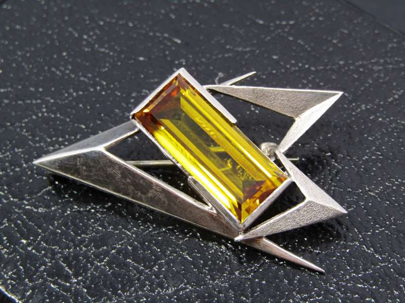 A Gorgeous Abstract Design Brooch With a Synthetic Gold Stone in Sterling Silver.