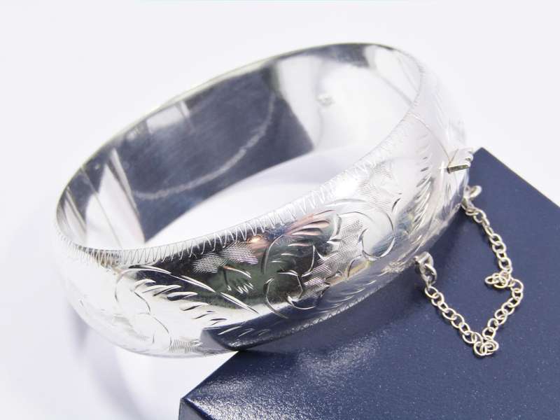 A Gorgeous Broad Engraved Vintage Design Hinged Bangle in Sterling Silver.