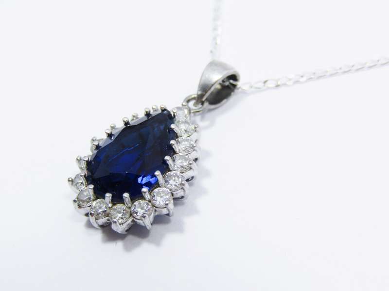 A Beautiful Royal Blue Teardrop Design Zirconia Pendant on Chain in Sterling Silver. R695   A