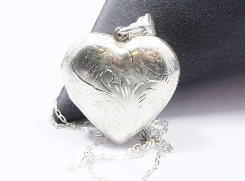 A Beautiful Vintage Design Engraved Heart Locket on Chain in Sterling Silver.