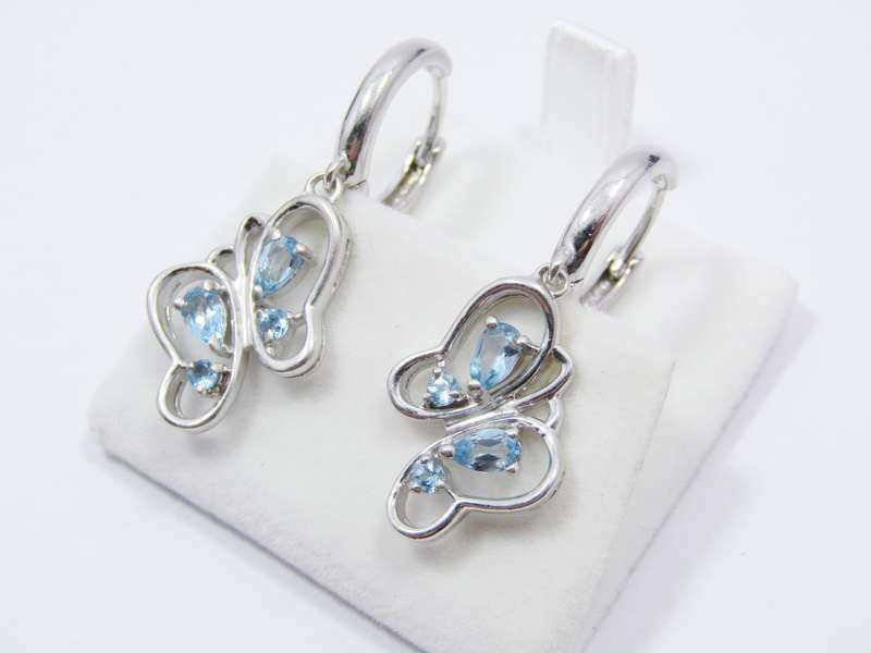 A Gorgeous Pair of Blue Topaz Butterfly Dangling earrings in Sterling Silver.