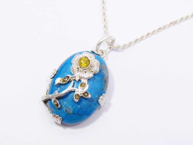 A Gorgeous Turquoise Color Stone Pendant With a Rose Detail on Chain in Sterling Silver