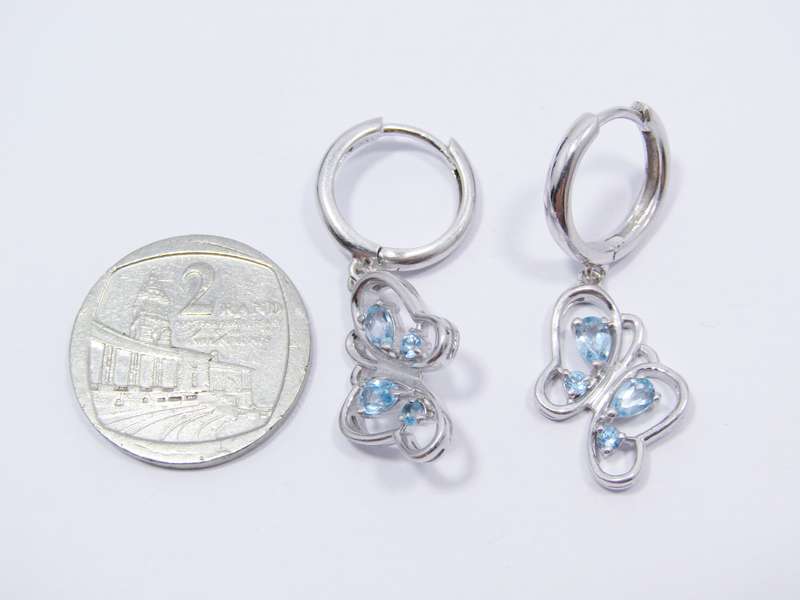 A Gorgeous Pair of Blue Topaz Butterfly Dangling earrings in Sterling Silver.