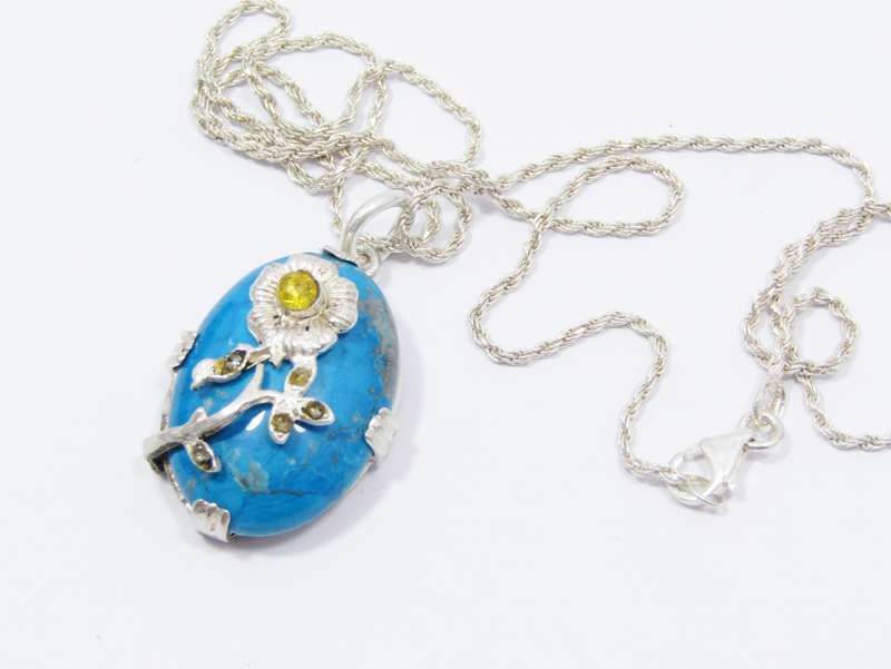 A Gorgeous Turquoise Color Stone Pendant With a Rose Detail on Chain in Sterling Silver