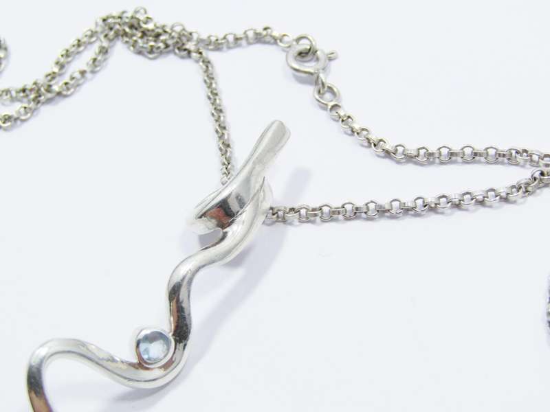 A Beautiful Swirl Design Zirconia Pendant on Chain in Sterling Silver.