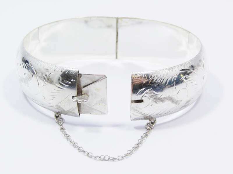 A Gorgeous Broad Engraved Vintage Design Hinged Bangle in Sterling Silver.