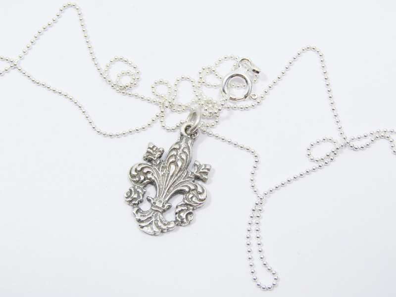A Stunning Fleur De Lis Pendant on chain in Sterling Silver.