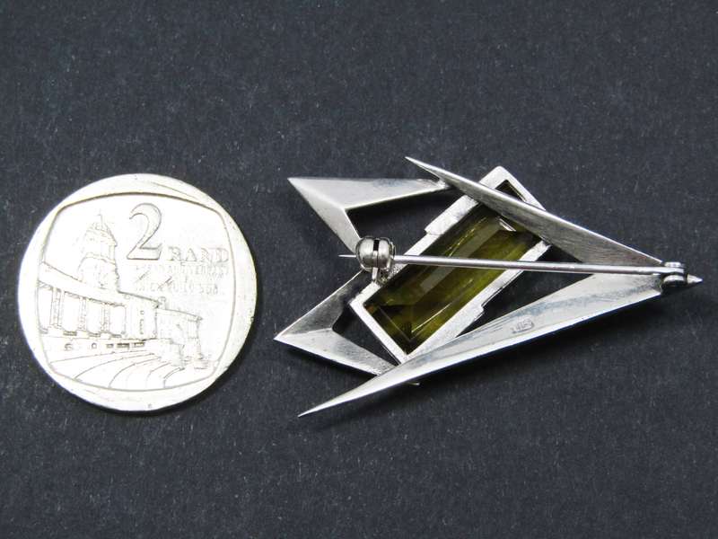 A Gorgeous Abstract Design Brooch With a Synthetic Gold Stone in Sterling Silver.
