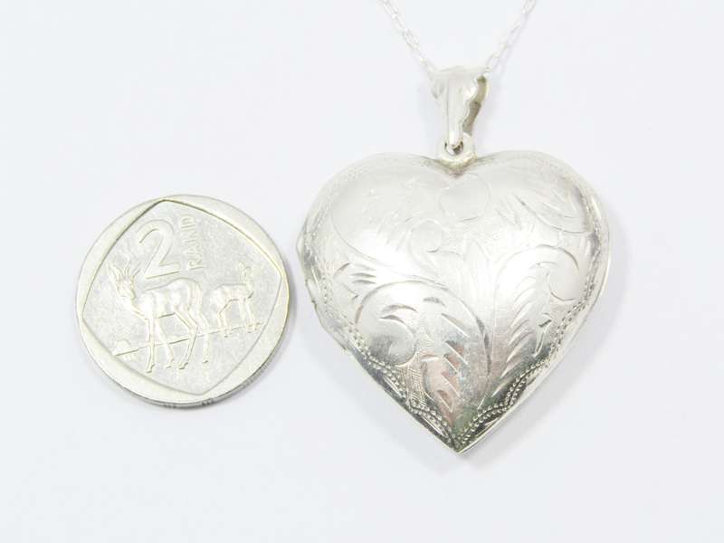 A Beautiful Vintage Design Engraved Heart Locket on Chain in Sterling Silver.