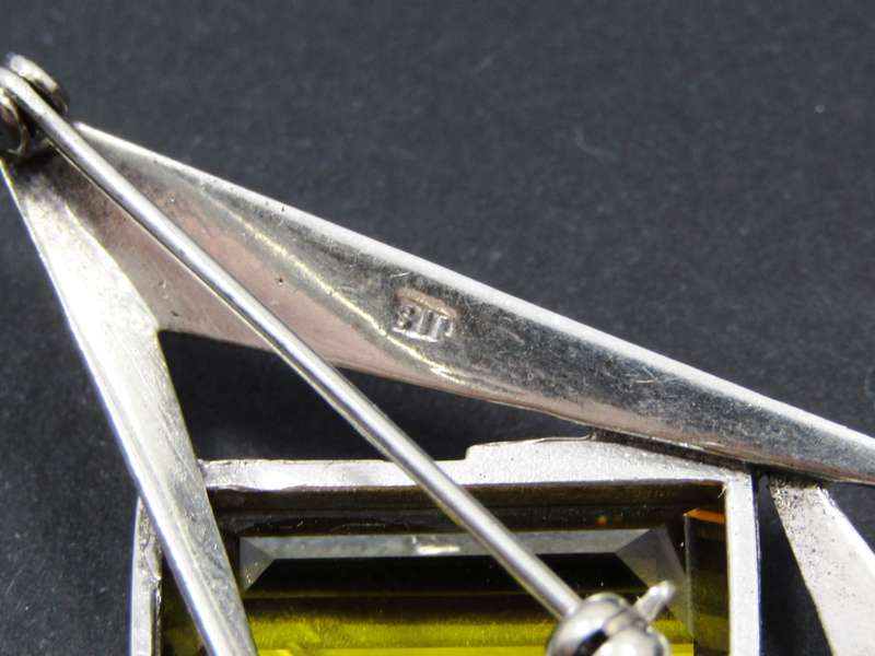 A Gorgeous Abstract Design Brooch With a Synthetic Gold Stone in Sterling Silver.