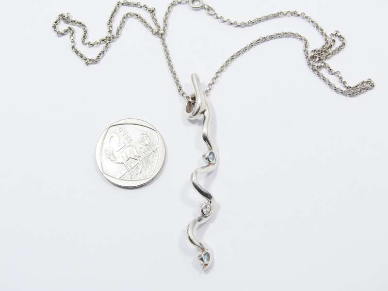 A Beautiful Swirl Design Zirconia Pendant on Chain in Sterling Silver.