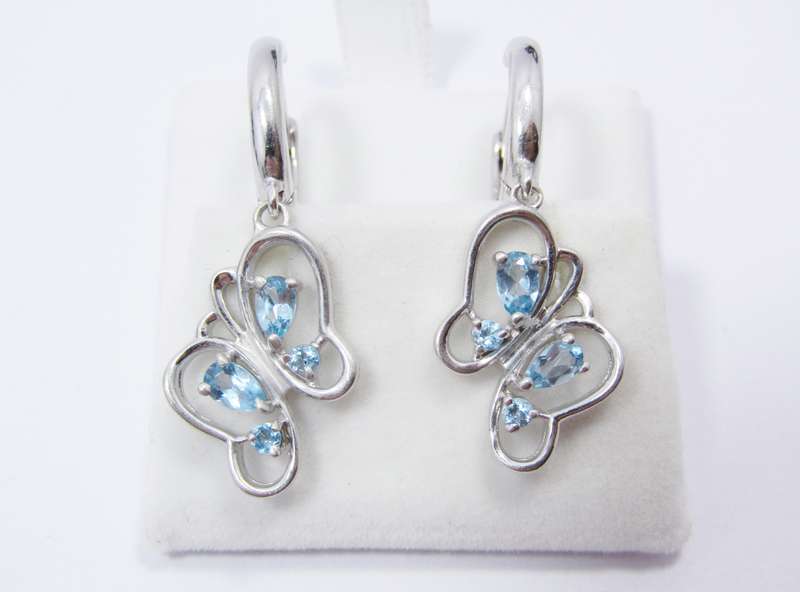 A Gorgeous Pair of Blue Topaz Butterfly Dangling earrings in Sterling Silver.