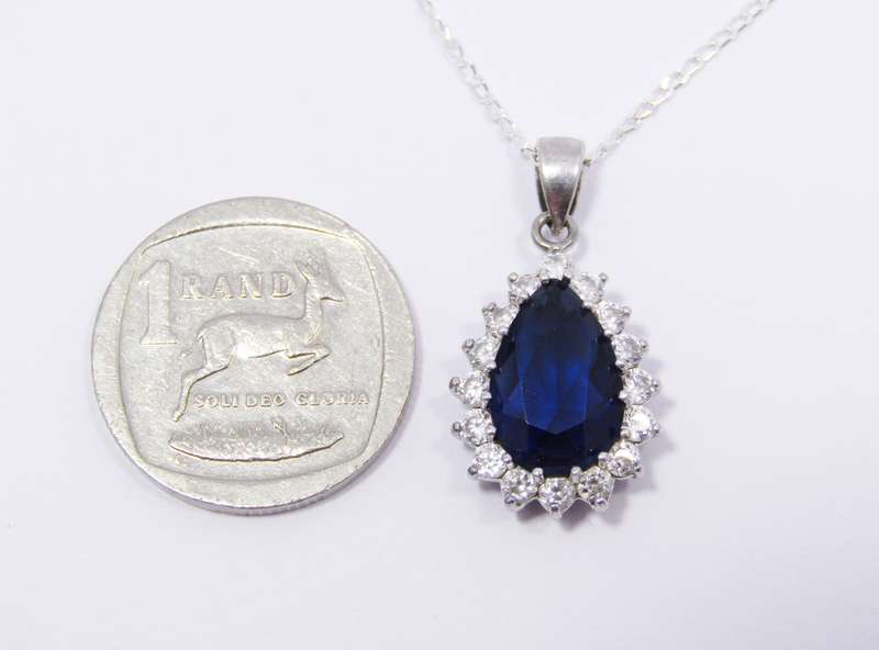 A Beautiful Royal Blue Teardrop Design Zirconia Pendant on Chain in Sterling Silver. R695   A